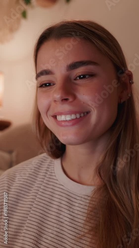 Happy Young Woman Interacting with Laptop in Cozy Home