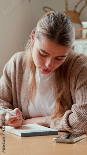 Young Woman Studies And Works From Home Kitchen