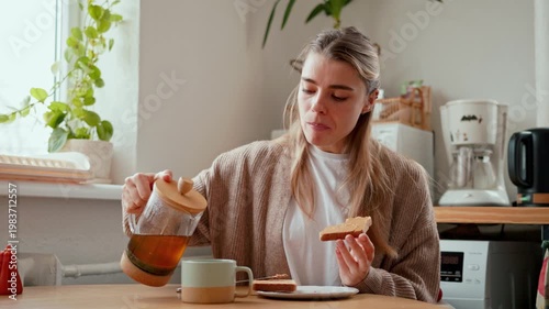 Young Woman Enjoys Breakfast With Tea At Home
