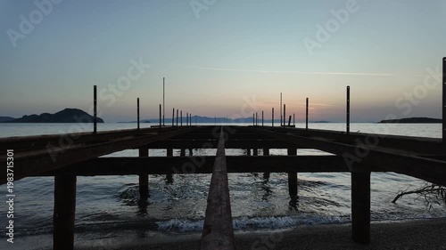 Cinematic Sunset Timelapse from the Top of an Abandoned and Dismantled Rusty Iron Pier on a Coastline