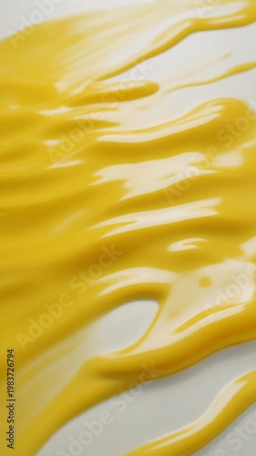 Yellow liquid splatter on gray surface