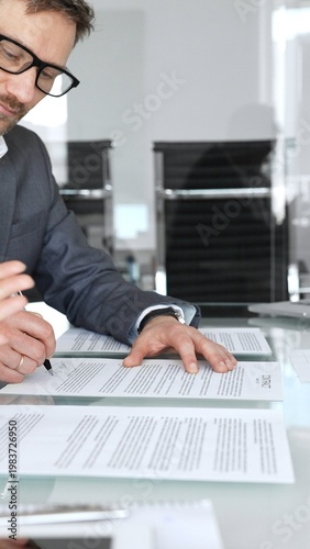 Photography Professional businessman signing a legal contract at a boardroom table during a
