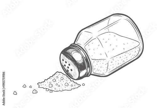 Tipped over glass salt shaker spilling coarse salt crystals