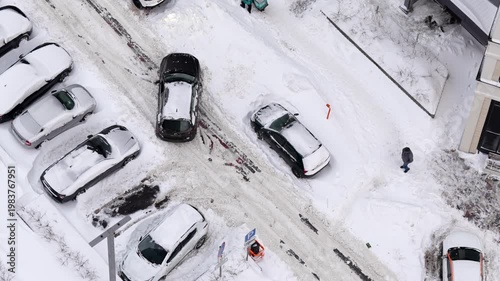 winter parking struggle snow-covered cars aerial view urban traffic city