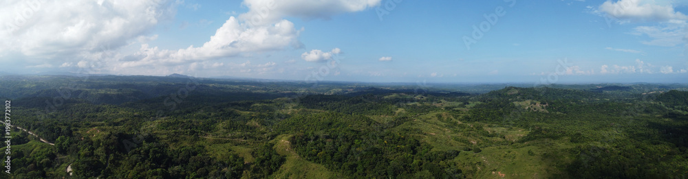 Fototapeta premium Panoramic aerial view of forest in norcasia Caldas, Colombia, blue sky nature landscape