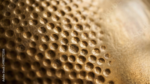 Hammered gold metal texture background with hand-crafted circular patterns
