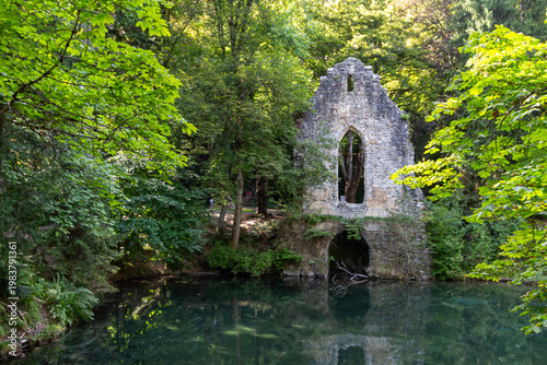 Chamonix-Mont-Blanc, Haute Savoie, France - August 09th, 2025: Sinclair artificial lake, with fakes ruined chapel and grotto, created to simulate the bucolic atmosphere of the lochs.