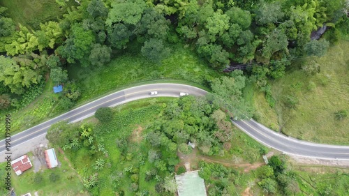 Top view drone shot road in mountains cars and motorcycle green area Cundinamamcar, Colombia. 4k