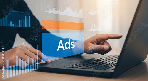 A person interacting with a laptop displaying ads and graphs
