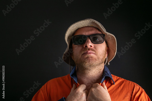 Manual worker adjusting collar of high visibility shirt, confident and serious