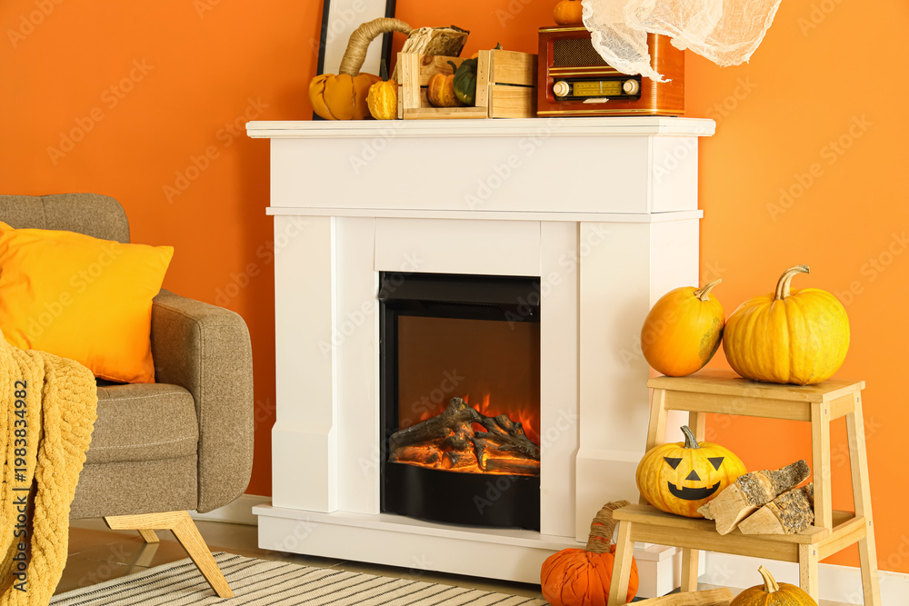 Obraz premium Interior of living room decorated for Halloween with fireplace, armchair and pumpkins