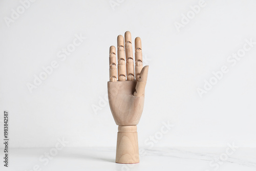 Wooden hand on white table