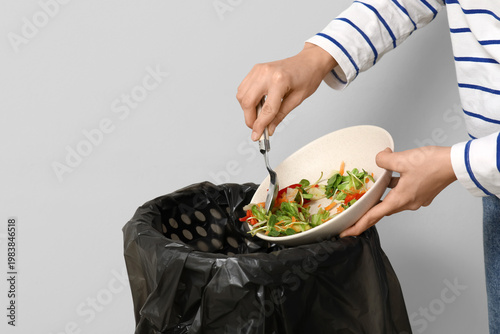 Young woman throwing organi...