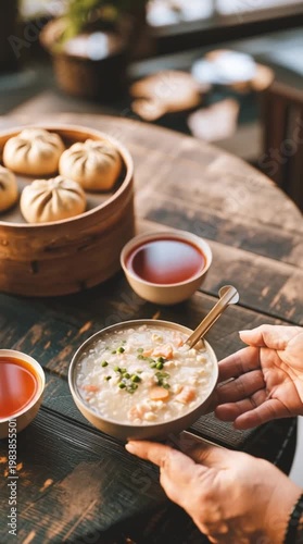 Chinese dumplings in bamboo steamer with sauce being poured, traditional dim sum cuisine, warm authentic Asian meal and rich flavorful food presentation.