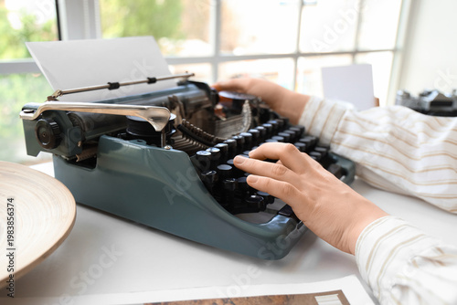Young woman typing on vinta...