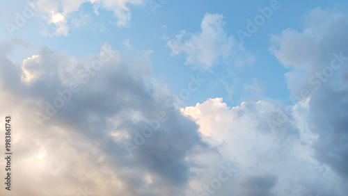 Tableau sur toile A white cloud against a slightly dark background with a blue sky