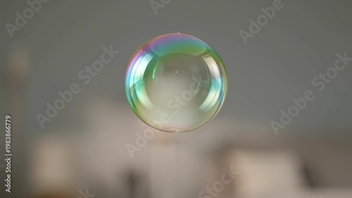 Ephemeral Orb: A mesmerizing close-up of a vibrant soap bubble suspended mid-air, its iridescent surface showcasing a spectrum of colors and ethereal beauty.
