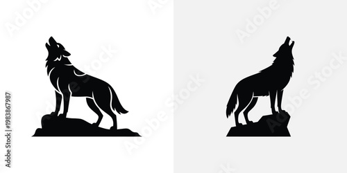 Black silhouette of two howling wolves on rocks wolf