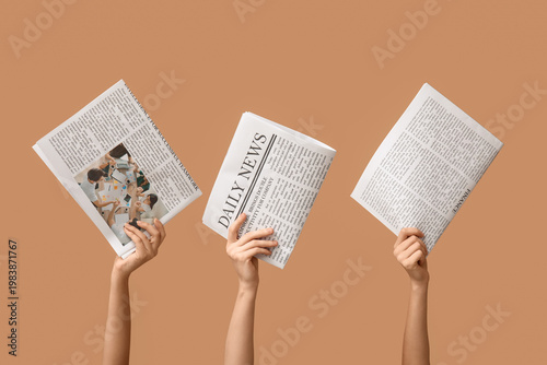 Women with newspapers on br...