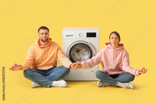 Young couple meditating whi...