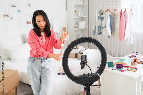 Young asian woman recording...