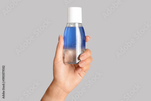 Young woman with bottle of ...