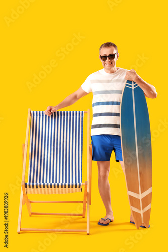 Mature man with surfboard a...