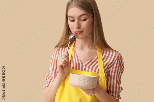 Young woman with spoon and ...