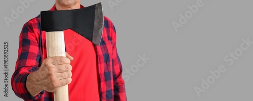 Man holding ax on grey back...