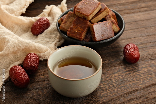 Using ancient methods to make brown sugar and brown sugar water, placing red dates on a wooden tabletop