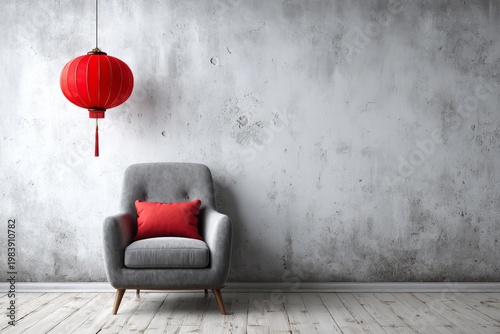 Gray armchair and red lantern against a textured wall.