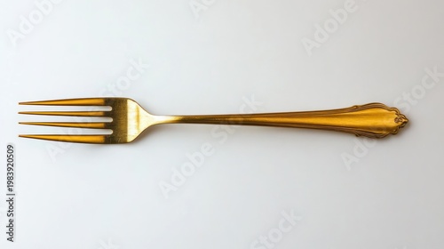 single ornate gold fork placed horizontally on clean white background, elegant refined mood