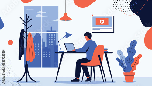 Young male freelancer sits at his desk working on a laptop in a modern apartment with a scenic window view of a metropolitan city during twilight.