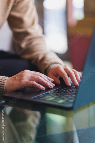 Fotografía Vertical closeup image of a woman hand working and typing on laptop computer