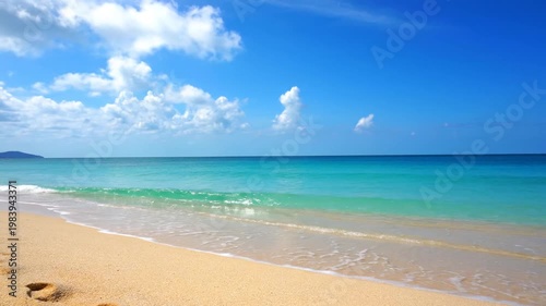 Tropical beach with ocean, sky, and sand.