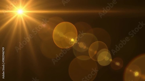 Golden light rays and bokeh on dark background