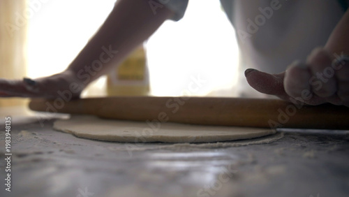 Billede på lærred woman hands making dough for bread or pizza, using rolling pin, Baking