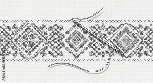 Close up of needle and thread on embroidered fabric.