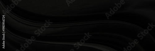 Black gray satin dark fabric texture luxurious shiny that is abstract silk cloth panorama background with patterns soft waves blur beautiful.