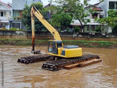 Принти на полотні Amphibious excavator in yellow, mounted on pontoons with track attachments, dred