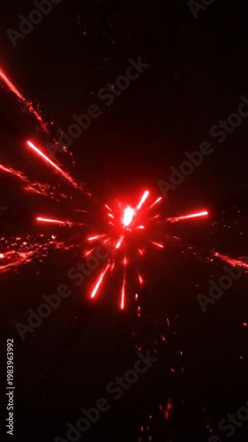 Red firework exploding in night sky