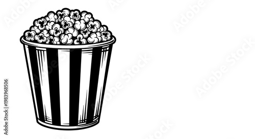Striped bucket full of popcorn movie snack.