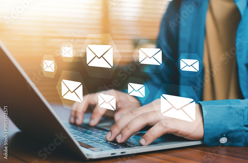Email communication concept with multiple message icons over laptop workspace, digital marketing campaign, inbox management, online messaging system, business communication, data exchange, modern