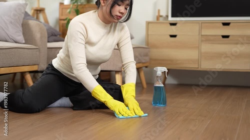 Cleanliness, asian young woman work chore cleaning floor at home, hand wearing glove using wiping cloth remove dust with spray bottle. Household hygiene clean up, equipment tool for cleaning