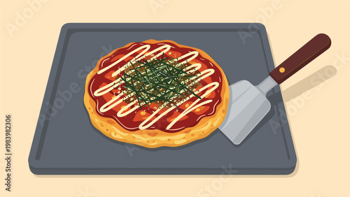 Savory Japanese okonomiyaki pancake is cooked on a flat griddle and served with a traditional metal spatula.