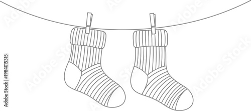A pair of socks hanging on a line with clothespins holding them up
