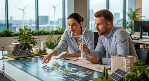 Two business professionals discussing a green energy project in an office setting.