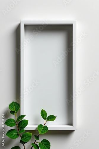 Minimalist white rectangular frame on clean wall with glossy green plant leaves overlapping corner, vivid natural contrast highlighting modern botanical decor and simplicity.