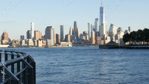 New York City Manhattan Downtown Financial District skyline, World Trade Center tower from New Jersey, Hoboken pier, United States of America. River waterfront urban cityscape with skyscraper building