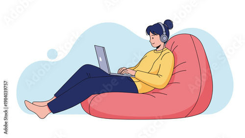 Relaxed woman wears headphones and works on her laptop computer while lounging comfortably in a large red bean bag chair at home.